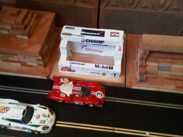 Scalextric Pits, Control Building, Restaurant, Grandstand. Similar to original range of plastic Scalextric Goodwood race buildings but in clay - built from mini bricks, painted (or not) and decals added.