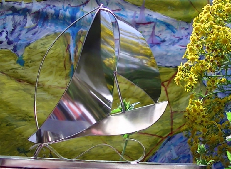 'Sailing Yacht with Spinnaker on Wave and Stand'.  290mm long, 80mm wide, 300mm high by  Dave Briggs. Original Sculpture �175. On display ClayClay shop.